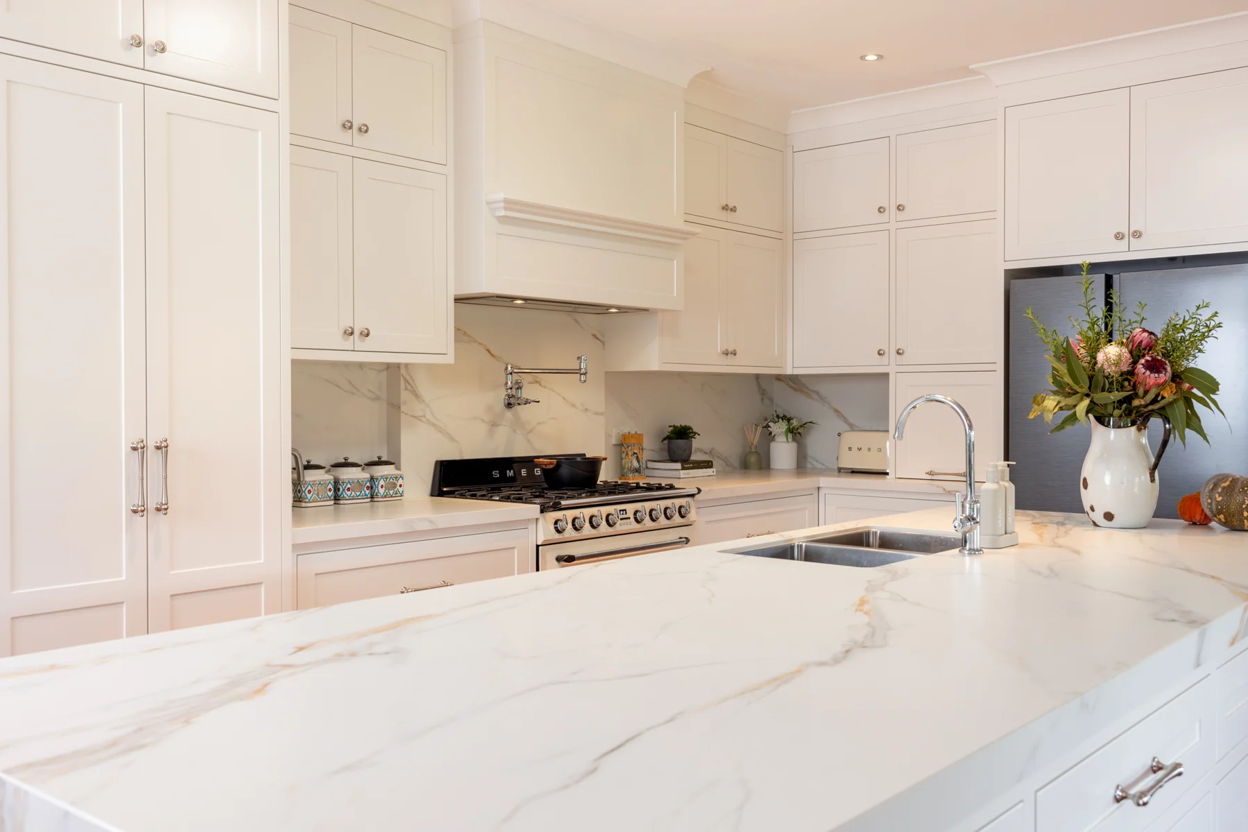 Wollombi kitchen with white shaker cabinetry, classic handles and island bench
